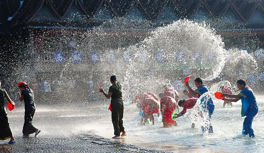 The Water-Splashing Festival in a Dai village, with water tossed in celebration.
