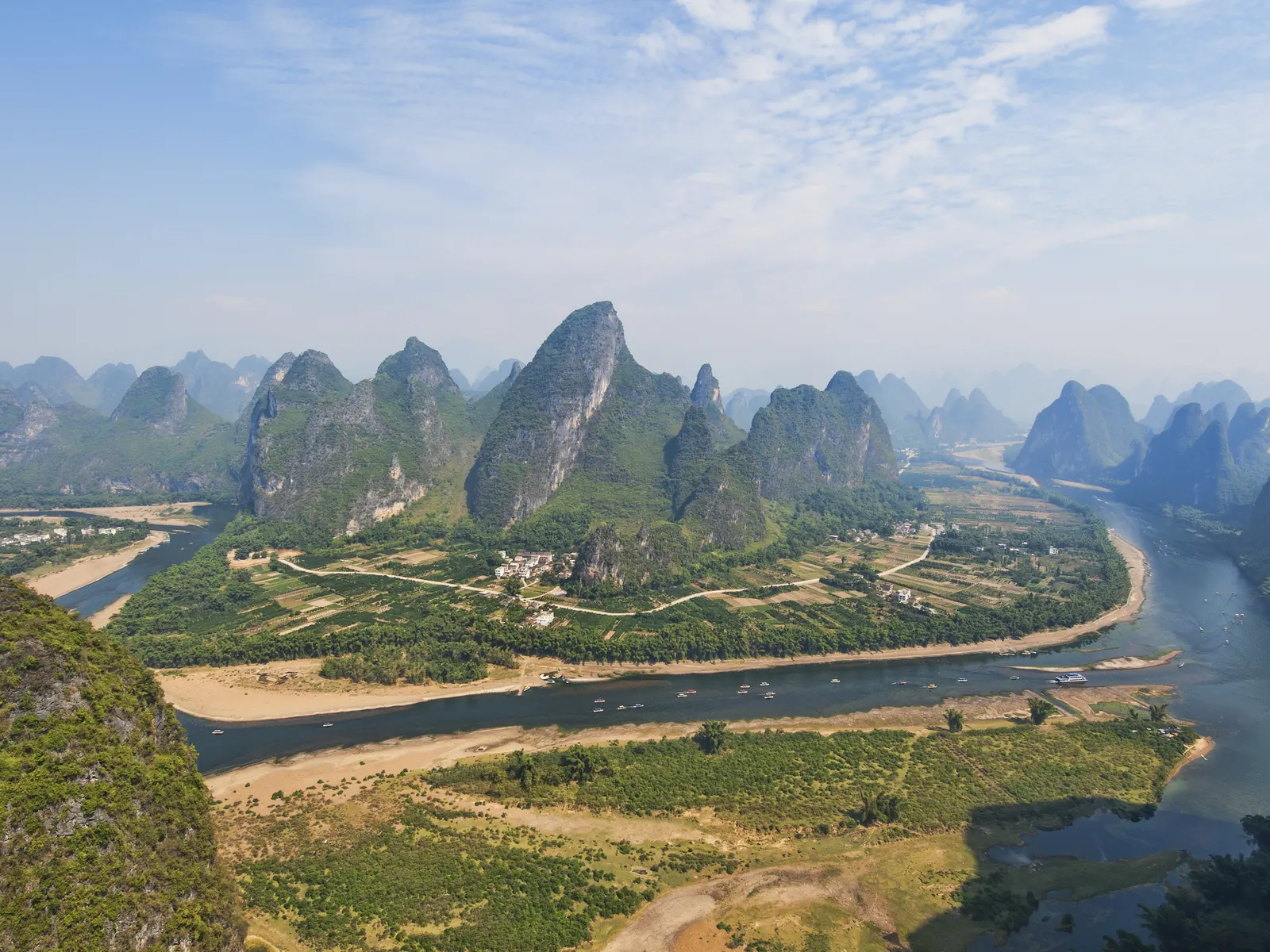 The Li River near Yangshuo: green karst peaks folded along the water like a scroll painting come to rest.