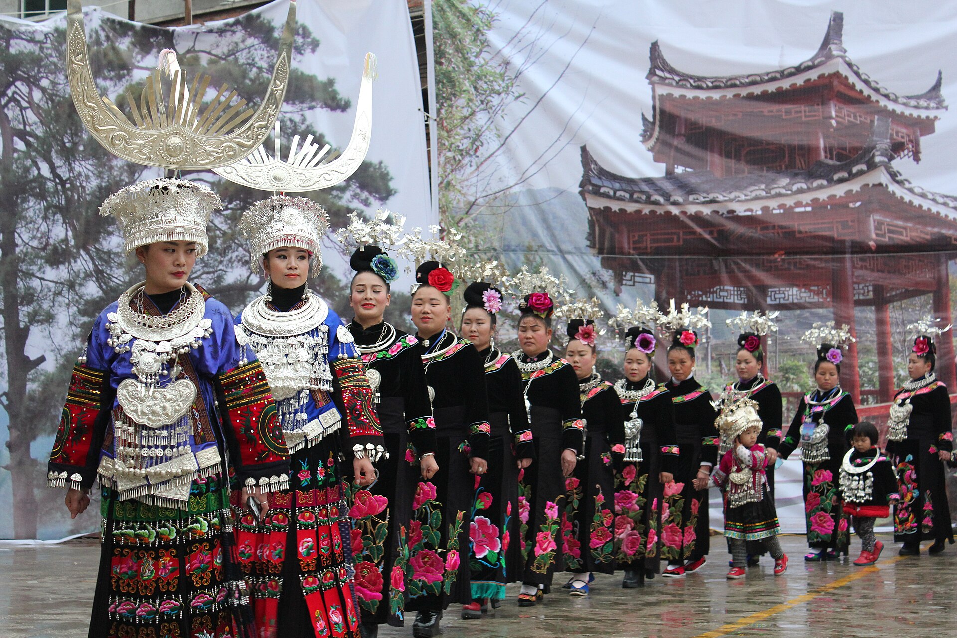 Miao women in festive clothing gather at a village celebration in Danjiang.