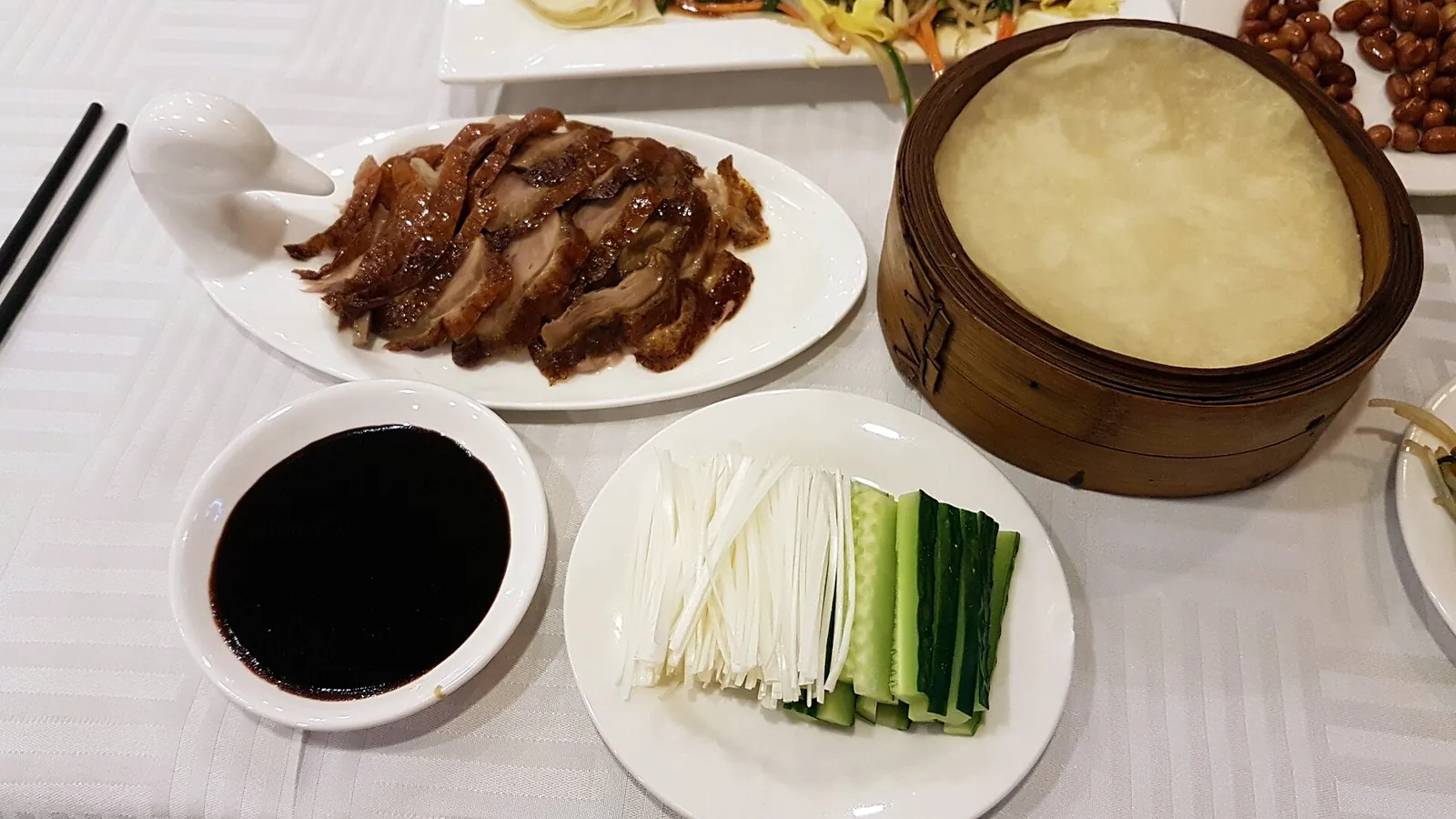 Sliced Peking duck served with pancakes and side dishes in Beijing.