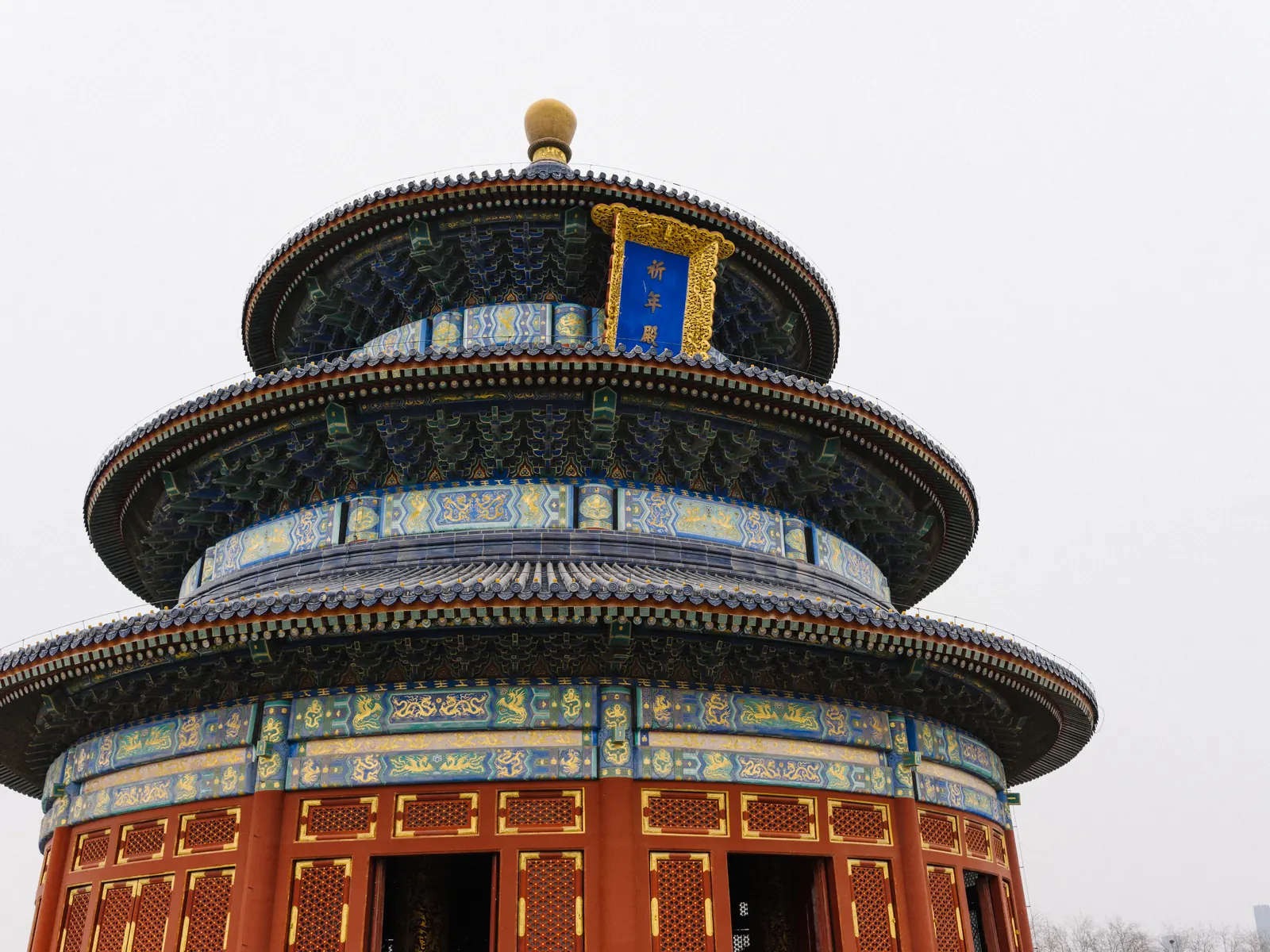 The Hall of Prayer for Good Harvests at the Temple of Heaven, its three tiers of deep blue glazed tile rising over a clear Beijing winter sky.
