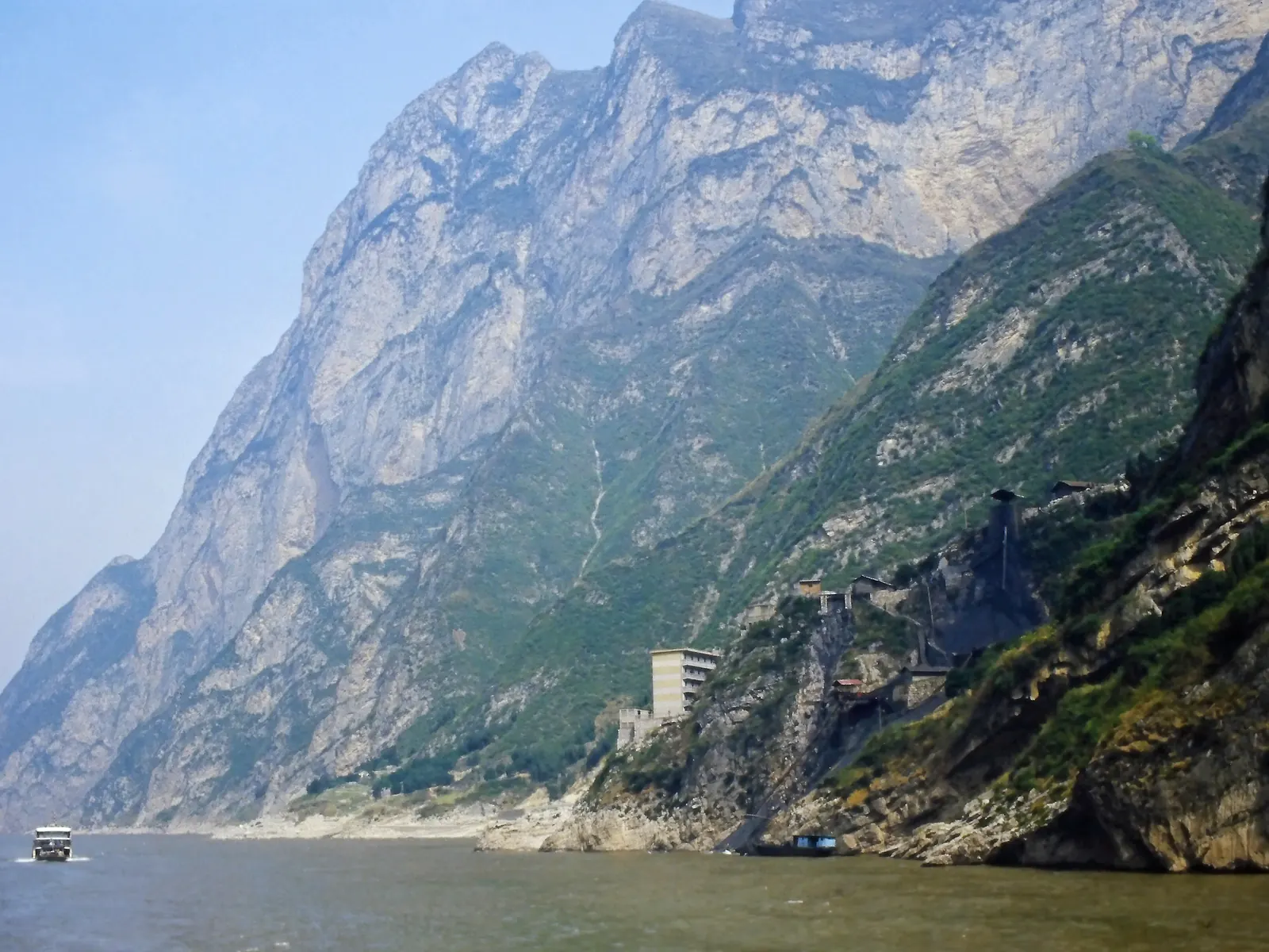 A boat dwarfed by the sheer limestone walls of Qutang Gorge near Kuimen on the Yangtze.