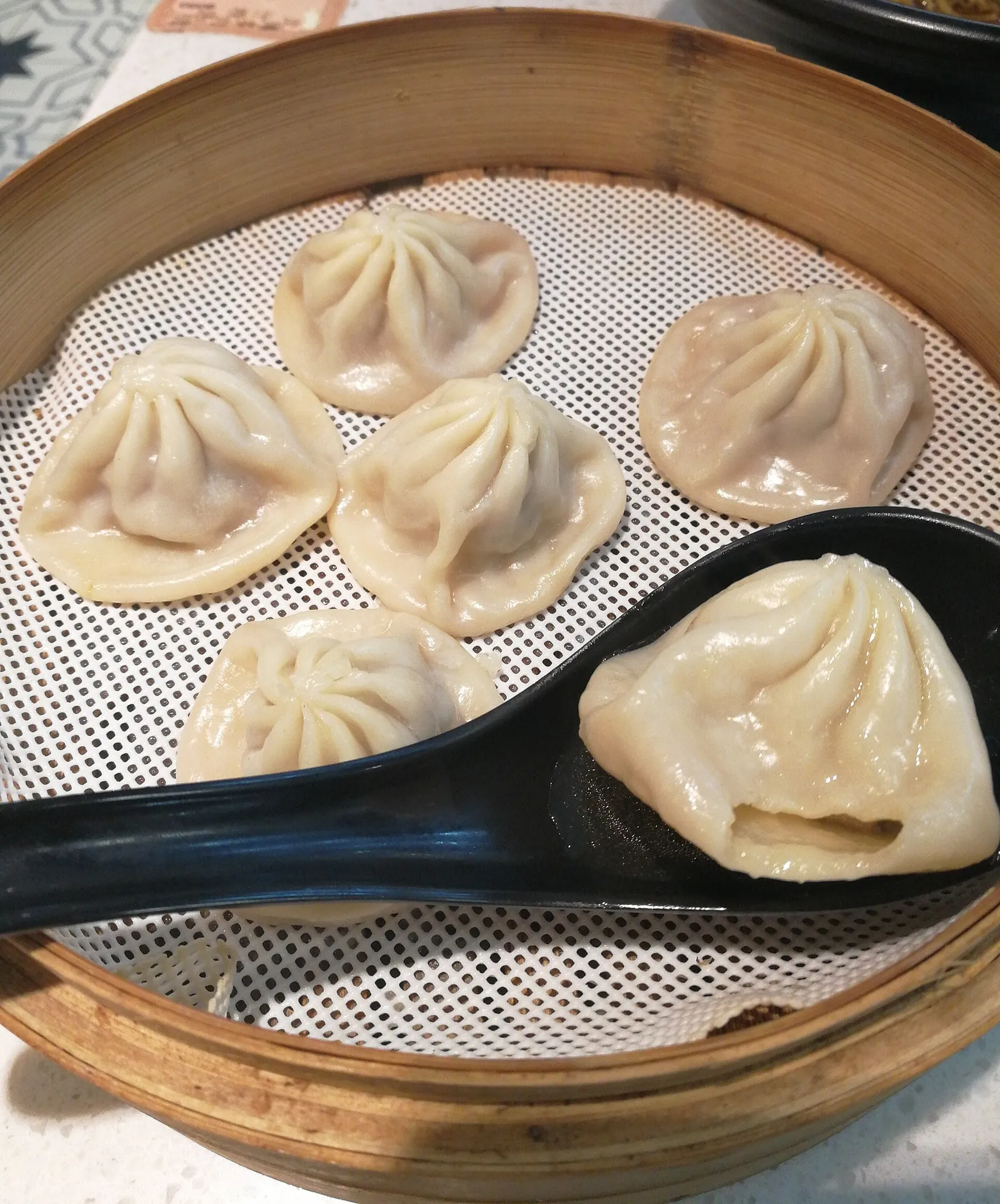 Steamer baskets of xiaolongbao soup dumplings fresh from the kitchen.