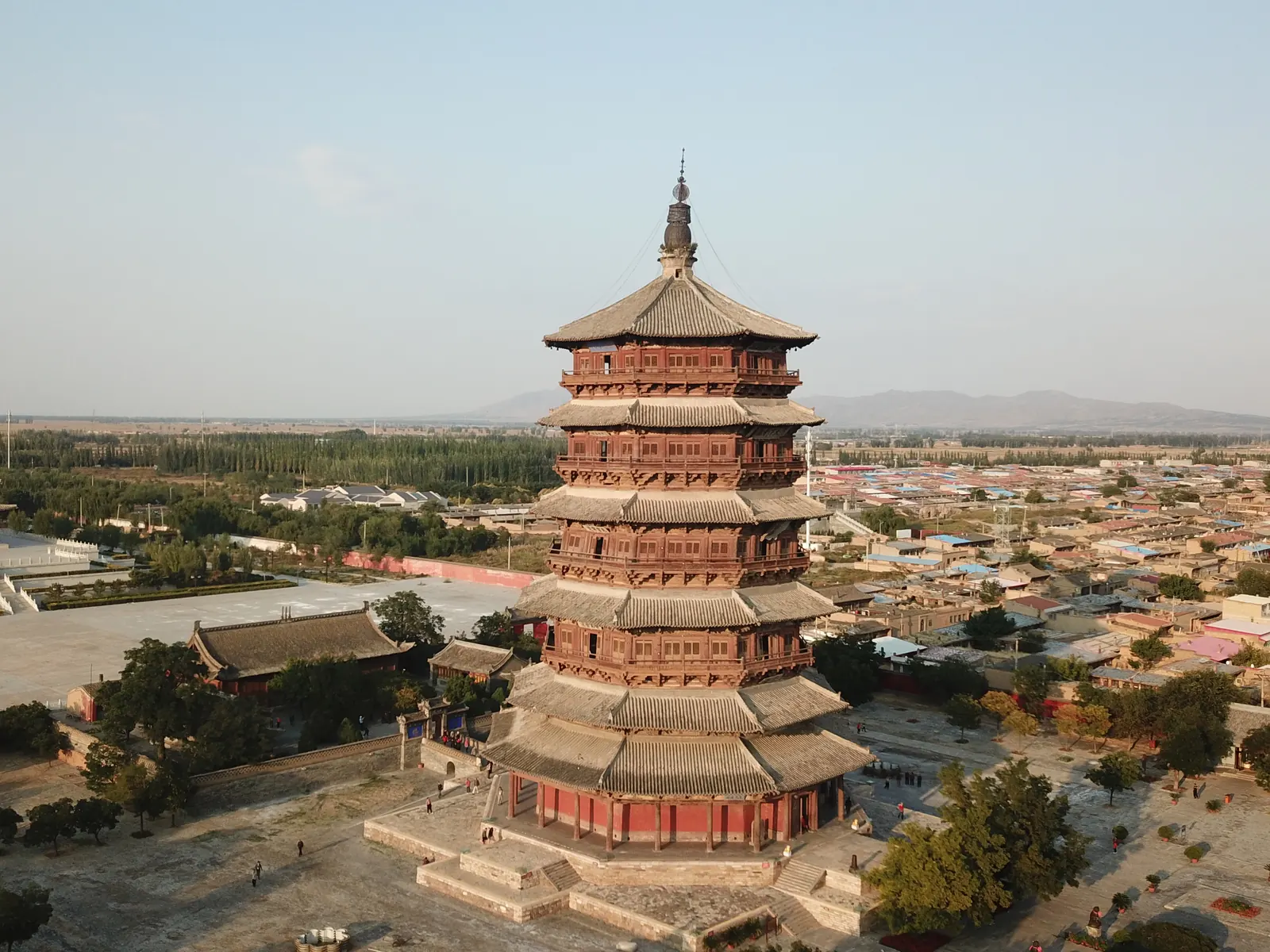 The full timber pagoda of Fogong Temple in Yingxian at dusk, its stacked eaves dark against an amber sky.